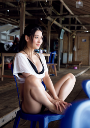 Ms. Eika Kamida is wearing a black bikini swimsuit, white shirt, she sits in a blue chair, she is a beautiful and cute Japanese & Asian bikini model (gravure idol, swimsuit model, pin-up girl), TV personality, actress, she used to be an idol singer.
