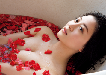 Ms. Eika Kamida is in the bathtub, bathed in red petals, she is lying in a bathtub with red petals, she is a beautiful and cute Japanese & Asian bikini model (gravure idol, swimsuit model, pin-up girl), TV personality, actress, and she used to be an idol singer.