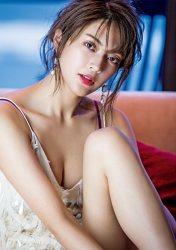 Ms. Michina Tauchi is wearing a white slip and sitting on a white sofa, she is a Japanese & Asian tall 9-headed mature female fashion model and actress.