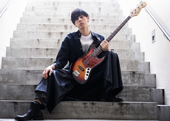 Mr. Ryuutarou wears black clothes and holds a guitar, he is a Japanese & Asian handsome fashion model.