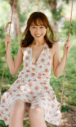 Ms. Syuuka Takatsu is a Japanese-Armenian mixed-race clothing beauty model (1/4 Armenian descent), she is a Japanese & Asian TV personality, fashion model, bikini model (gravure idol), she is wearing a white dress (with a floral pattern), and she is sitting on a swing.