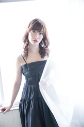 Ms. Ayaka is wearing a black dress, she is a beautiful & cute Japanese & Asian model, freelance announcer, TV personality, she holds a white curtain by the window.