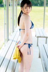 Ms. Kirara is an actress, gravure idol (bikini model, swimsuit model pin-up girl) and wears a blue bikini swimsuit, she is standing on the bench.