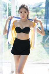 Ms. Yuina wears a colorful short-sleeved shirt with a black bra and black shorts underneath, she's about to take off her shirt, she is in the room, she is a Japanese & Asian fashion model, actress and swimsuit model (gravure idol, bikini model).