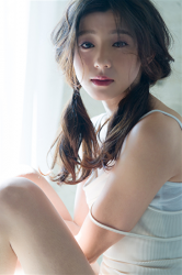 Ms. Ayami Asashige is wearing a white camisole, she is sitting on the floor, she is a tall Japanese & Asian beautiful and elegant fashion model, gravure idol (bikini model, swimwear model, pin-up model), TV personality, and actress.