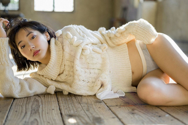 Ms. Karena Takeoka is wearing a white sweater, she is lying on the wooden floor, she is a cute and elegant Japanese actress (Asian actress), print bikini model (gravure idol, swimsuit model, pin-up model), fashion model.