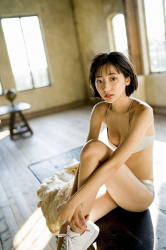 Ms. Karena Takeoka took off her white sweater and showed her gray underwear, she was sitting on the table, she is a cute and elegant Japanese actress (Asian actress), bikini model (gravure idol, swimsuit model, pin-up model), fashion model.