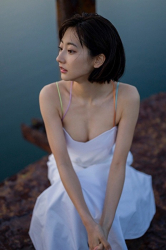 Ms. Karena Takeoka is wearing a white dress, she is squatting, she is a cute and elegant Japanese actress (Asian actress), bikini model (gravure idol, swimwear model), fashion model.