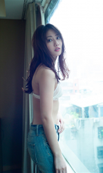 Ms. Kazuki Okuike is wearing white bra and jeans, she is standing by the window, she is a beautiful and elegant Japanese & Asian fashion model, bikini model (gravure idol, bikini model, swimwear model, pin-up model) actress, her bust is 83cm and she has beautiful breasts.