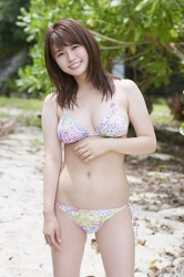 Ms. Maaya is standing in a white bikini swimsuit (with a hint of purple), she is a beautiful and cute Japanese & Asian gravure idol (bikini model, swimwear model, pin-up girl), TV personality, she has beautiful breasts.