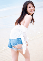 Ms. Mioka Imawatari wears white long-sleeved shirt and denim shorts, she is standing on the sandy beach, she is a beautiful and cute Japanese actress (Asian actress), gravure idol (bikini model, swimwear model, pin-up model), TV personality, her bust is 86cm, she has beautiful breasts.
