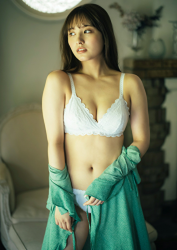 Ms. Nanane Oka is wearing green clothes and white underwear, she is standing, she is looking sideways, behind her is a white chair, she is a beautiful and cute Japanese & Asian gravure idol (bikini model, swimsuit model, pin-up girl) and actress.