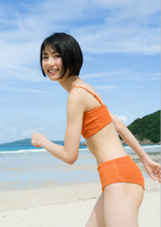 Ms. Natsuyo Ikekatsu is wearing an orange bikini swimsuit, she is standing on the sandy beach, she is a Japanese & Asian beautiful and cute model & actress.