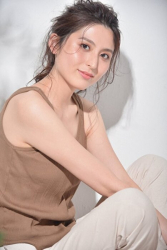 Ms. Atsumi Aonami wears brown short sleeve shirt, beige trousers, she is sitting, she is a beautiful and elegant mature Japanese & Asian fashion model, her height is 173 cm, her body is very slender and pretty.