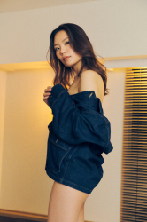 Ms. Eri Noina hides herself with a denim jacket, she is standing in the room, she is a tall and beautiful Japanese & Asian fashion model, parts model, her height is 171 cm, she is tall, and her figure is very slim and beauty woman.