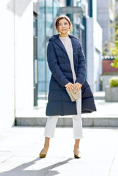 Ms. Akie Shibukawa is a beautiful Japanese & Asian fashion model, wearing a blue jumper and white clothes, she stands in a certain town.