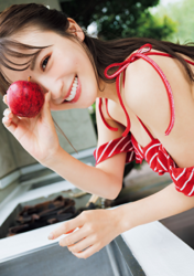 Ms. Emina Iori is a Japanese and Asian gravure idol (swimwear model, bikini model, pin-up girl), TV personality and singer, she is in the kitchen wearing a red leotard and holding an apple.