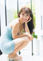 Ms. Emina is a Japanese and Asian gravure idol (swimwear model, bikini model, pin-up girl), TV personality and singer, she is squatting in a light blue dress and sandals.