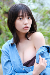 Ms. Kiira Kikuoki is a Japanese & Asian gravure idol (swimwear model, bikini model, pin-up model) and actress, she wears a baggy blue shirt and reveals a purple brassiere in a photo that emphasizes her face.