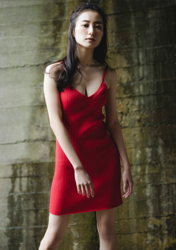 Ms. Mariho is a Japanese & Asian fashion model, swimsuit model (gravure idol / bikini model / pin-up girl), actress, and former idol, she is wearing a red dress and standing.