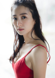 Ms. Mariho is a Japanese & Asian fashion model, swimsuit model (gravure idol / bikini model / pin-up girl), actress, and former idol, she is wearing a red dress and standing.