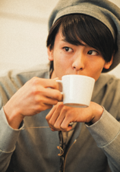 Mr. Akisato Takasho is wearing gray clothes and a gray hat, holding a glass and drinking a drink, he is a Japanese & Asian model, actor, talent, singer, and dancer.