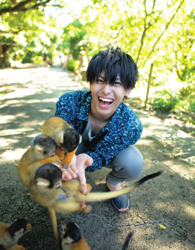 Mr. Akisato Takasho is dressed in blue and playing with a little monkey, he is a Japanese & Asian model, actor, talent, singer, and dancer.