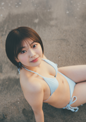 Ms. Ami Ojimi is a young gravure idol (bikini model / swimwear model) and a young and cute actress, she is wearing a light blue bikini and sitting on the beach.