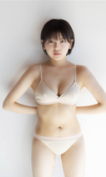 Ms. Ami Ojimi is a young gravure idol (bikini model / swimwear model) and a young and cute actress, she is wearing a white lingerie and she is standing.