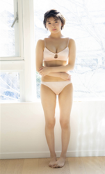 Ms. Ami Ojimi is a young gravure idol (bikini model / swimwear model) and a young and cute actress, she is wearing very pale pink color lingerie and she is standing.