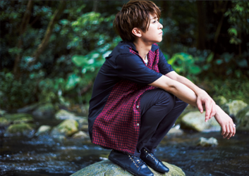 Mr. Ayato Akaibashi is wearing a dark cutter shirt and pants and is squatting on a rock in the middle of the river, he is also an actor and voice actor.