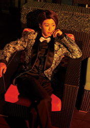 Mr. Ayato Akaibashi is wearing a suit and sitting on a chair, he is also an actor and voice actor.