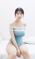 Ms. Kiira Kikuoki is a Japanese & Asian gravure idol (swimwear model, bikini model, pin-up model) and actress, she wears a blue leotard and she is sitting on the bed.