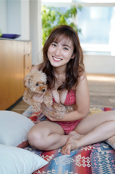 Ms. Yaaya Igeta is wearing a red bikini, holding a cute brown dog and sitting cross-legged on the floor, she is a Japanese & Asian gravure idol (bikini model, swimsuit model, pin-up girl), actress, TV personality, her bust is 92 cm, she has attractive big breasts, she is a sexually attractive woman.