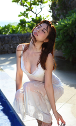 Ms. Yumika Sugiomi wears a white bikini and translucent white slip and squats by the pool, she is a beautiful and elegant Japanese & Asian fashion model, gravure idol (bikini model, swimsuit model, pin-up girl), actress, female singer, her bust is 84 cm, she has beautiful breasts, she has attractive women.