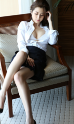 Ms. Yumika Sugiomi has her white shirt unbuttoned, revealing a white bra, wearing a navy blue skirt and black high heels, sitting on a chair, she is a beautiful and elegant Japanese & Asian fashion model, gravure idol (bikini model, swimsuit model, pin-up girl), actress, female singer, her bust is 84 cm, she has beautiful breasts, she has attractive women.
