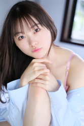 Ms. Makiko Tatsuhashi is taking off her light blue cut shirt and she is sitting on the bed, she is an active idol singer and gravure idol (bikini model, swimwear model).