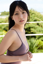 Ms. Uuna Tadekawa is a beautiful and cute young Japanese gravure idol (pin-up girl, swimwear model, bikini model), she is wearing a light purple swimsuit and is standing on the balcony.
